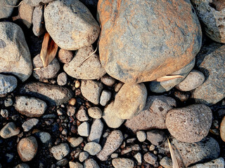 A close-up image of a smooth, rounded river stone collection