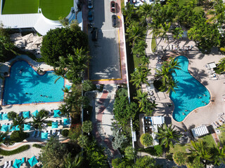 Fototapeta premium Luxury Hotel resort in Miami beach with swimming pool and palm tree for summer vacation travel