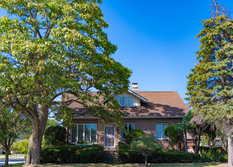 Suburban house architecture. Private family house. Neighborhood architecture. Property in neighborhood. Residential property house. Residence architecture. Suburban neighborhood. Private life