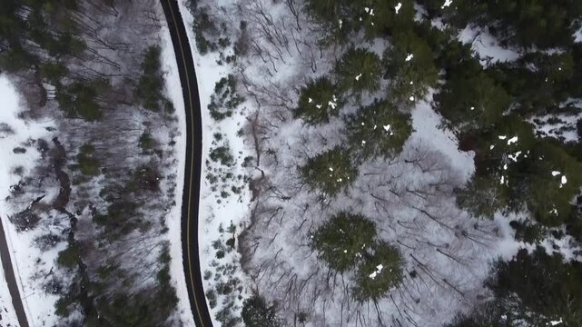 Aerial Top-Down shot of Snowy road in the mountains of Macedonia in Grevena, Greece