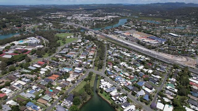 View From Above Of Cavemans Lake, Currumbin Creek, And Pacific Motorway In Palm Beach, QLD, Australia. aerial pullback shot