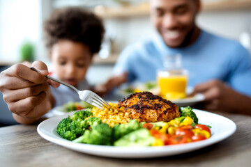 A family enjoying a healthy meal together, featuring grilled chicken, rice, and vibrant vegetables, promoting bonding over nutritious food.