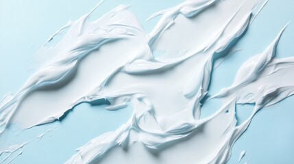 Abstract swirls of white cream on a light blue background.