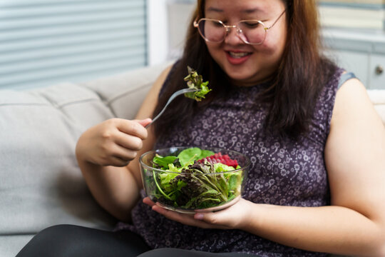 Asian Overweight woman dieting Weight loss eating fresh fresh homemade salad healthy eating concept Obese Woman with weight diet lifestyle. - Powered by Adobe
