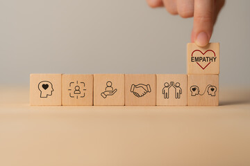Empathy concept. Wooden blocks with empathy icons on minimal background and copy space. The power...