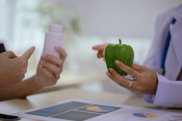Nutritionist giving consultation to patient with healthy fruit and vegetable, Right nutrition and...