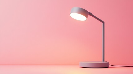 Illuminated desk lamp on pink background.