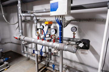 Piping system installation in a modern industrial facility with gauges and control units