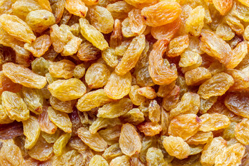 Natural raisins made from white grapes. Texture a lot of raisins.