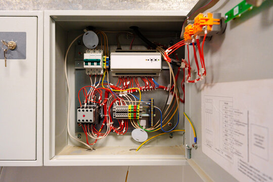 Complex wiring setup inside an electrical control cabinet for industrial applications in a commercial building
