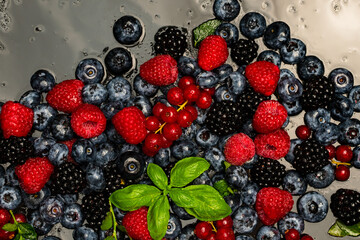 Wild berries. Ripe blackberries, blueberries, raspberries. Mix of garden berries. Forest fruit berry mix. Texture background. Ripe berries background.