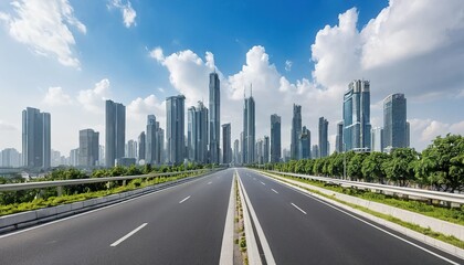 Empty highway leading to modern city skyline with tall skyscrapers and lush green trees. Sunlight and fluffy white clouds in a clear blue sky.