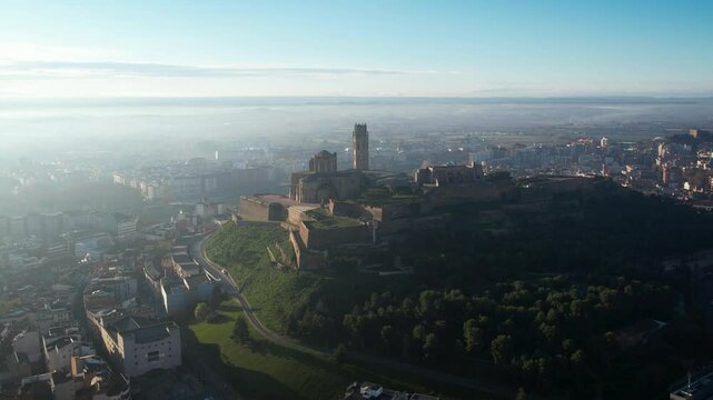 Majestic old cathedral on top of the hill and sorrounded by the city of Lleida in Catalonia, Spain. High quality 4k drone footage