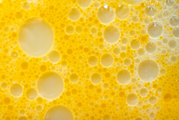 Texture of fat or oil with yellow bubbles. Background of fat bubbles