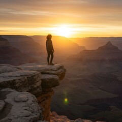 Fototapeta premium A person standing at the edge of a cliff overlooking a sunrise, representing hope. Mental Health concept.