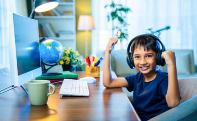Young Indian Kid Engaged in Online Class from Home Using Computer, Focused on Studies and Learning