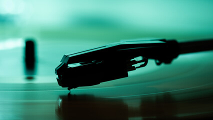 A close-up record player needle on a vinyl record