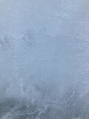 Close-up of an ice wall with small cracks. Outdoors in winter. Frozen.