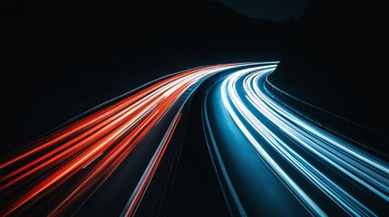 Light streaks from cars passing on a city street at night, with a long exposure effect capturing vibrant colors and movement