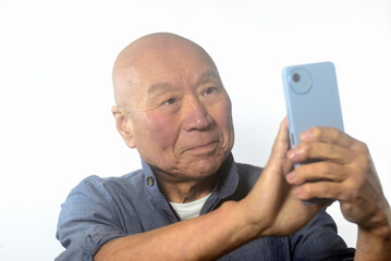 笑顔でスマートフォンを操作する老人