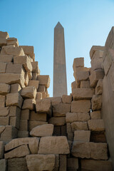 Ancient Egyptian abelisk among destroyed stone blocks