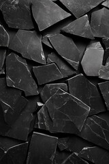 High-resolution image of black slate stones with irregular shapes, perfect for backgrounds or textures in design projects.