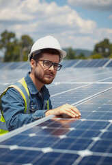 Solar Panel Inspection: Engineer Examining Panels at Solar Farm

