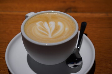 Enjoying a beautifully crafted latte in a cafe in Tallinn, Estonia during a cozy afternoon