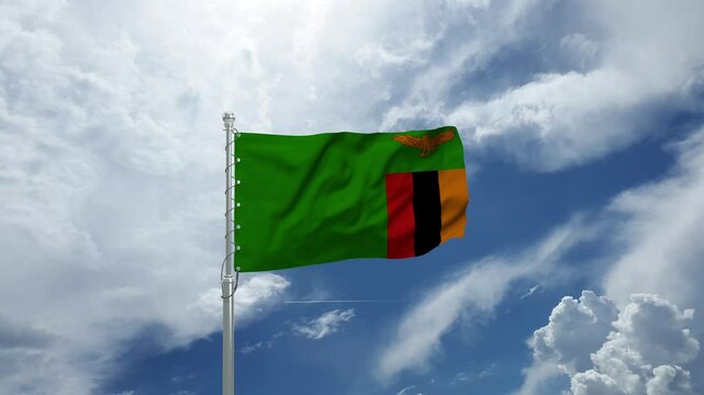 Zambia Flag Waving Majestically on a Flagpole Against a Clear Blue Sky in Gentle Wind