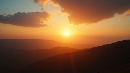 Golden sunset sky with soft clouds glowing over mountain range, serene evening nature scene perfect for travel, relaxation, outdoor adventure, background, landscape, peaceful atmosphere warm light