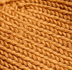 A close up of a knitted item with a brown color