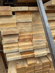A stack of wood planks with a metal bar on top