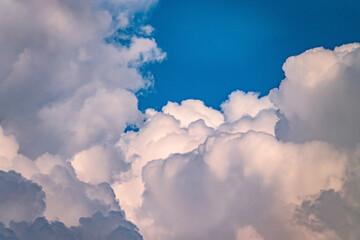 fluffy clouds over blue sky