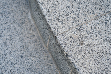 Detailed view of a granite surface showing a crack and texture in natural light