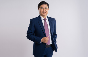 portrait of elderly asian businessman posing on white background