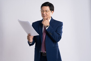 portrait of elderly asian businessman posing on white background