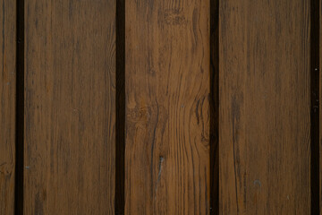 Wooden planks of varying shades arranged in a neat pattern for a rustic interior design aesthetic