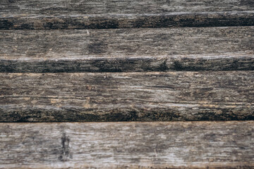 Close-up view of weathered wooden planks on a deck in natural light during the afternoon