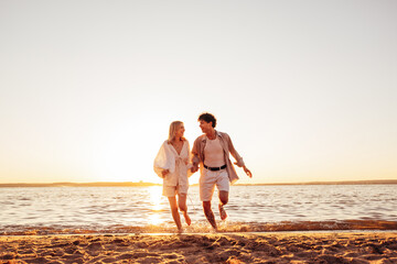 Smiling beautiful woman and her handsome boyfriend. Excited couple in casual clothes. Happy...