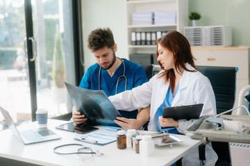 Fototapeta premium Doctors analyzing results or diagnosis of patient in clinic. Teamwork, medical and healthcare workers