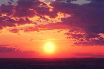Fototapeta premium Beautiful sunset with a large sun in the sky. The sky is filled with clouds, creating a moody atmosphere