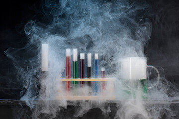Chemistry glassware test tubes measuring jugs with colourful liquids and swirling smoke