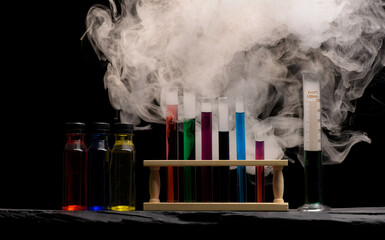 Chemistry glassware test tubes measuring jugs with colourful liquids and swirling smoke