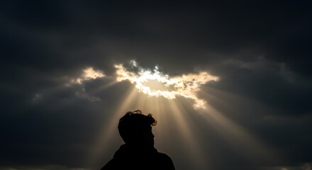A dark cloud above a man's head, with a ray of sunlight piercing through. Depression. Mental Health. Anxiety. Stress. Life crisis. Sad.