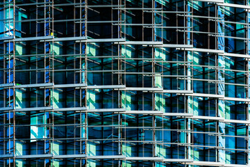 Glass Building Facade with Complex Steel Framework and Reflective Blue Windows