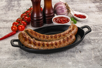 Grilled beef sausages with sauce