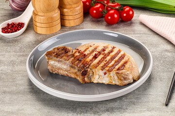 Grilled pork loin steak with bone