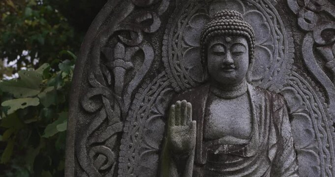 A religious stone statue of Medicine Buddha at Japanese buddhism temple