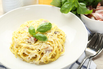 Delicious pasta Carbonara served on table, closeup