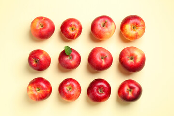 Many red apples on beige background, flat lay